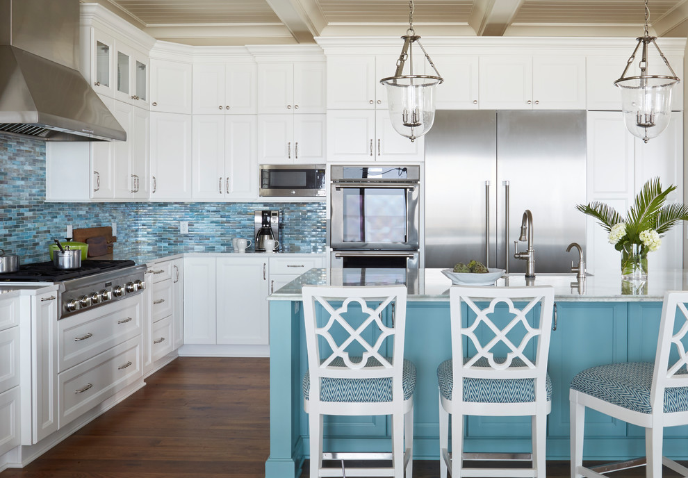 Inspiration for a large beach style l-shaped open plan kitchen in Jacksonville with a farmhouse sink, recessed-panel cabinets, turquoise cabinets, quartzite benchtops, blue splashback, glass tile splashback, stainless steel appliances, medium hardwood floors, with island and brown floor.