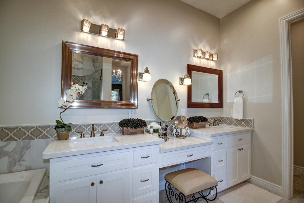 Mid-sized traditional master bathroom in Sacramento with shaker cabinets, white cabinets, a one-piece toilet, beige walls, ceramic floors, a drop-in sink, quartzite benchtops, multi-coloured floor, white benchtops, an enclosed toilet, a double vanity, a built-in vanity, a hot tub and marble.
