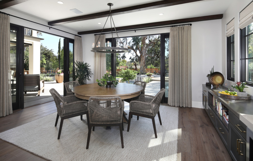 Inspiration for a mediterranean dining room in Orange County with grey walls, dark hardwood floors, no fireplace and exposed beam.