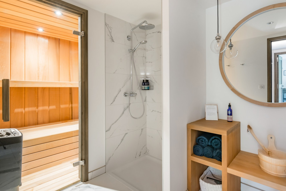 Mid-sized contemporary bathroom in Other with flat-panel cabinets, light wood cabinets, an open shower, a wall-mount toilet, white tile, marble, white walls, marble floors, with a sauna, a wall-mount sink, wood benchtops, white floor, an open shower and brown benchtops.