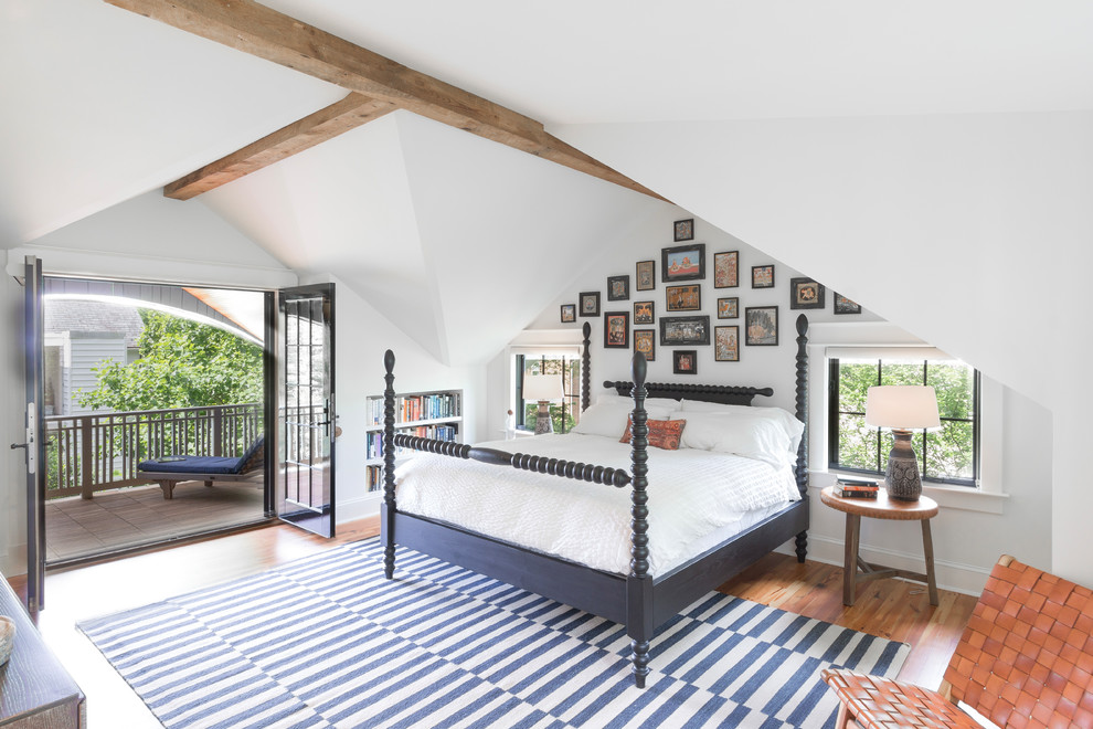 Photo of a contemporary bedroom in DC Metro with white walls and medium hardwood floors.