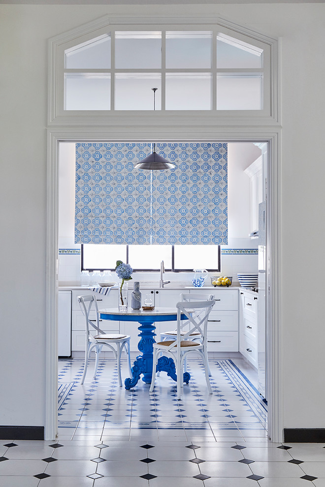 Inspiration for a traditional l-shaped eat-in kitchen in Singapore with raised-panel cabinets, white cabinets, white splashback, no island and multi-coloured floor.