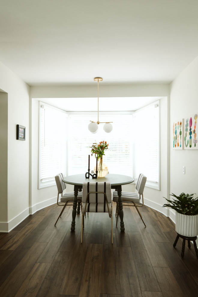 Small traditional separate dining room in Grand Rapids with white walls, vinyl floors, no fireplace and brown floor.