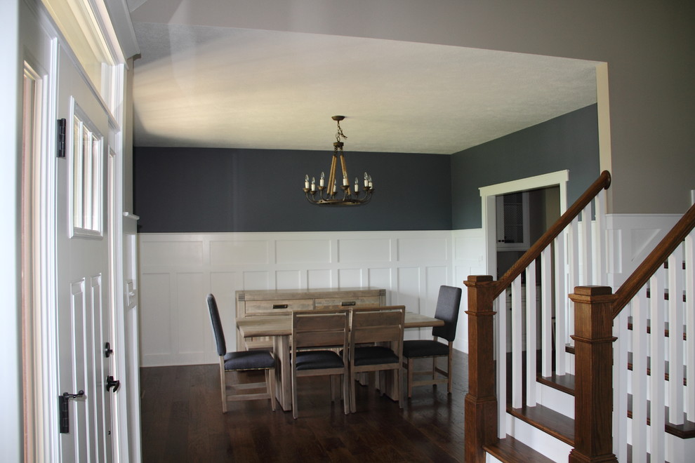 Front door - dark wood floor front door idea with beige walls and a white front door
