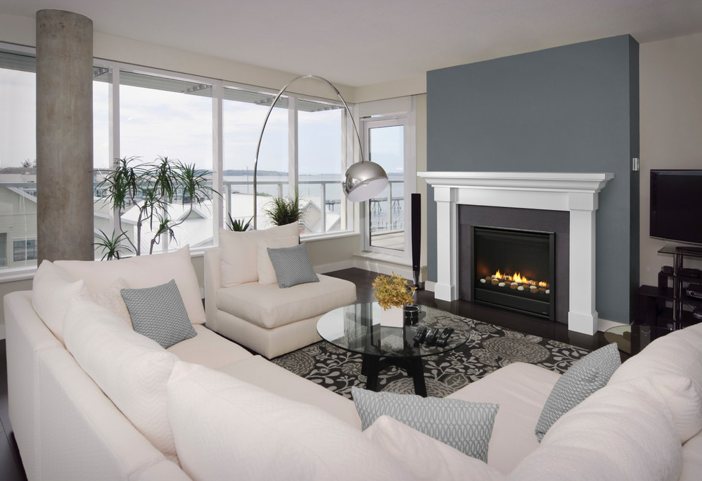 Inspiration for a mid-sized beach style formal enclosed living room in Las Vegas with grey walls, dark hardwood floors, a standard fireplace, a stone fireplace surround, no tv and brown floor.