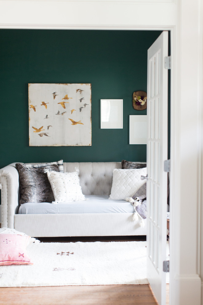 Example of a mid-sized eclectic enclosed light wood floor and brown floor family room design in Atlanta with green walls, no fireplace and no tv