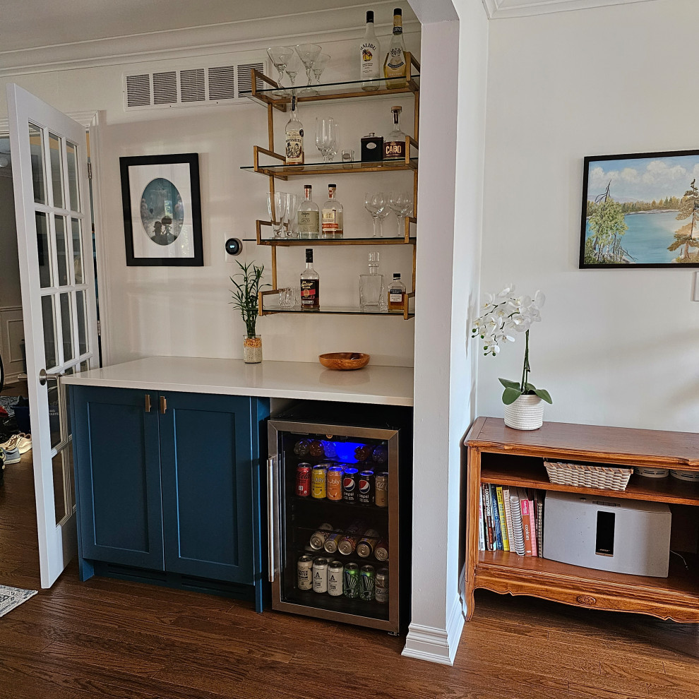 Midcentury home bar in Toronto with shaker cabinets, blue cabinets, quartzite benchtops and blue benchtop.