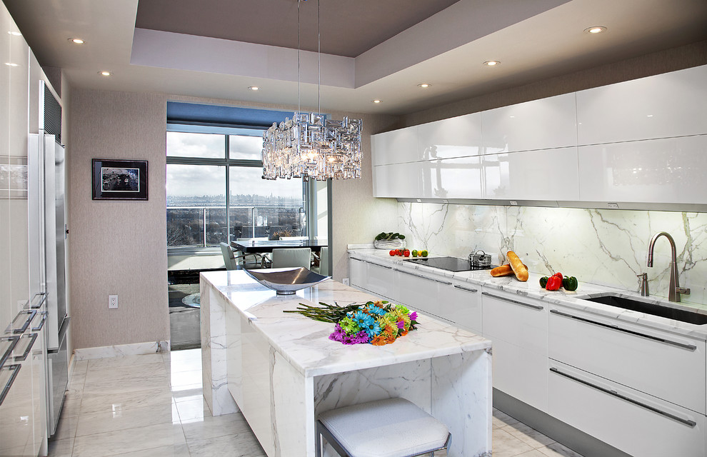 This is an example of a mid-sized contemporary galley kitchen in New York with an undermount sink, flat-panel cabinets, white cabinets, marble benchtops, white splashback, stone slab splashback and marble floors.
