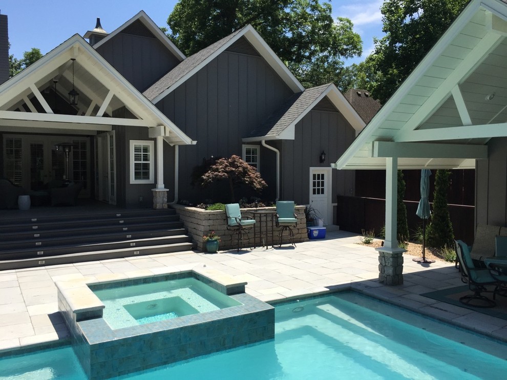 Inspiration for a large transitional backyard concrete paver and rectangular hot tub remodel