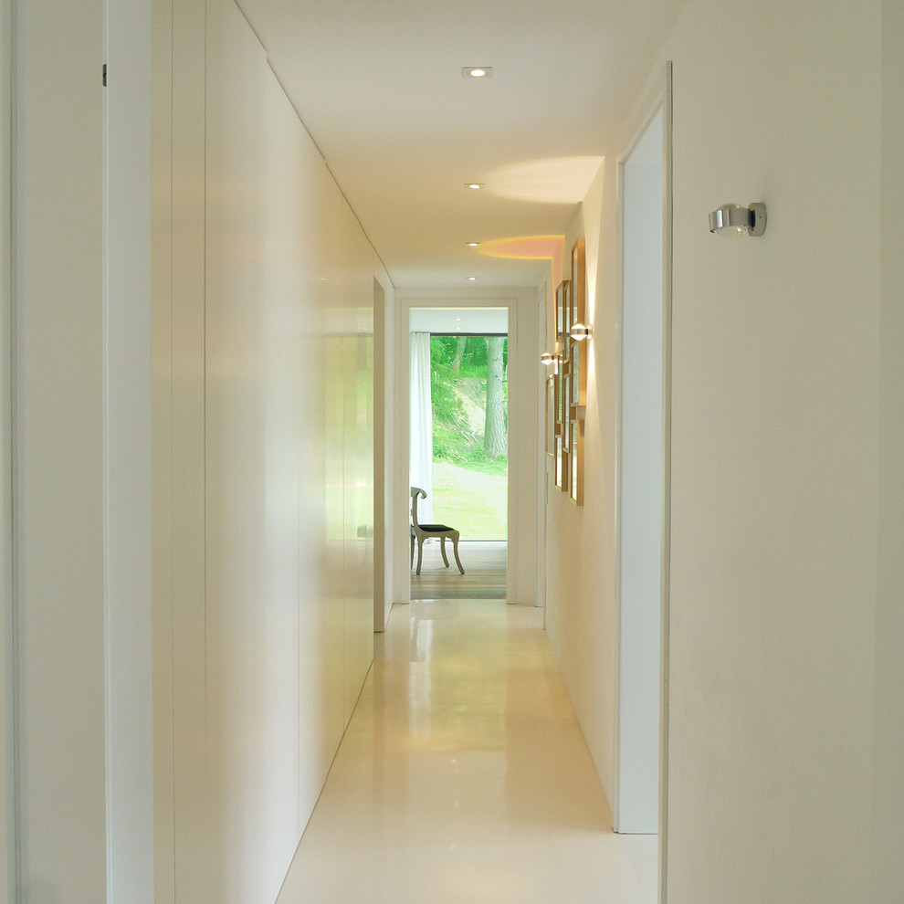 Large contemporary hallway in Hanover with white walls.