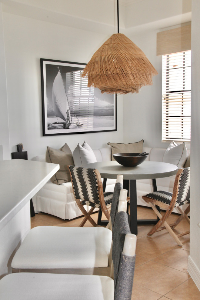 Photo of a small contemporary dining room in Miami with white walls, ceramic floors, no fireplace, beige floor, recessed and planked wall panelling.
