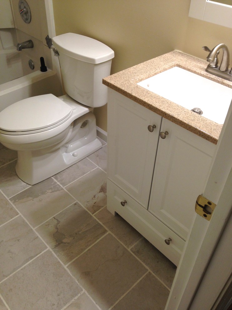 Design ideas for a small transitional 3/4 bathroom in Other with an integrated sink, flat-panel cabinets, white cabinets, solid surface benchtops, an alcove tub, a shower/bathtub combo, a one-piece toilet, white tile, porcelain tile, beige walls and porcelain floors.