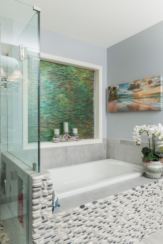 Small beach style master porcelain tile and gray floor drop-in bathtub photo in Atlanta with recessed-panel cabinets, blue walls, an undermount sink and granite countertops