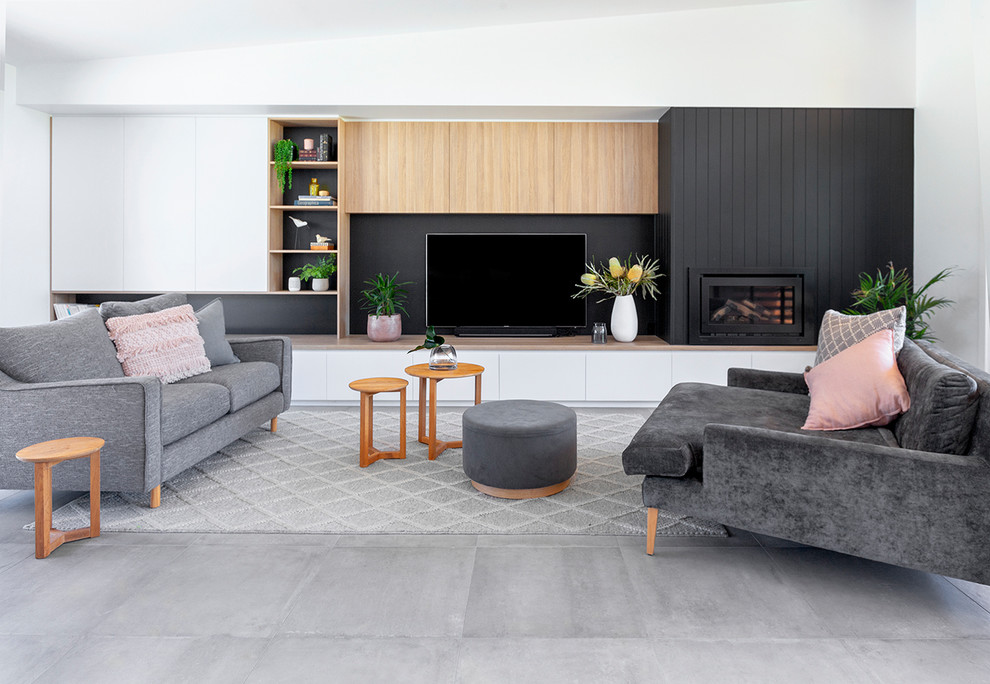 Large contemporary formal open concept living room in Geelong with white walls, ceramic floors, a wood fireplace surround, a wall-mounted tv, grey floor and a standard fireplace.