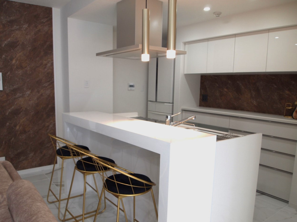 This is an example of a transitional kitchen in Other with white cabinets, white splashback, marble floors, white floor, white benchtop and wallpaper.