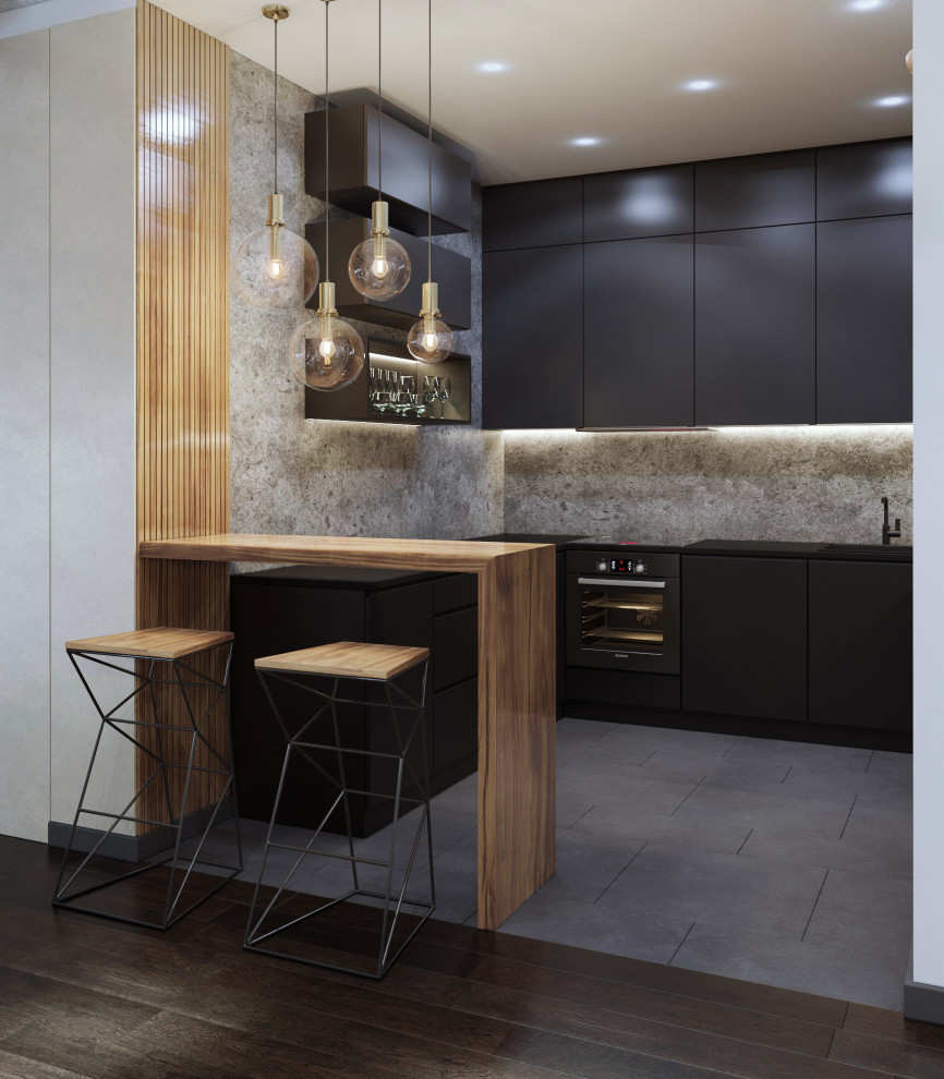Inspiration pour une petite cuisine ouverte design en L avec un placard à porte plane, des portes de placard noires, une crédence grise et un sol gris.
