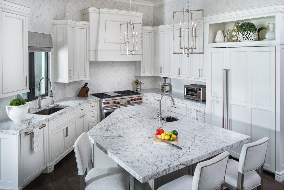Inspiration for a large transitional u-shaped porcelain tile and brown floor eat-in kitchen remodel in Orlando with an undermount sink, recessed-panel cabinets, white cabinets, quartz countertops, white backsplash, marble backsplash, stainless steel appliances, an island and gray countertops