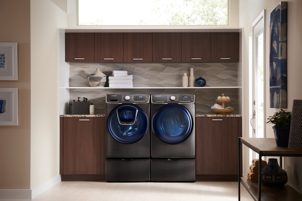 Design ideas for a mid-sized modern single-wall utility room in Other with flat-panel cabinets, medium wood cabinets, granite benchtops, beige walls and a side-by-side washer and dryer.