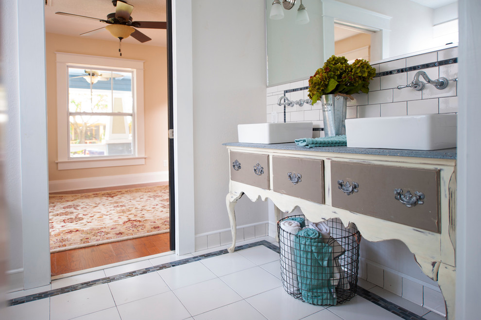 Mid-sized arts and crafts kids bathroom in Tampa with furniture-like cabinets, light wood cabinets, a corner shower, a two-piece toilet, white tile, ceramic tile, grey walls, ceramic floors, a vessel sink, wood benchtops and white floor.