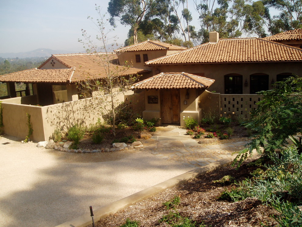Design ideas for a large mediterranean stucco house exterior in San Diego with a shingle roof.