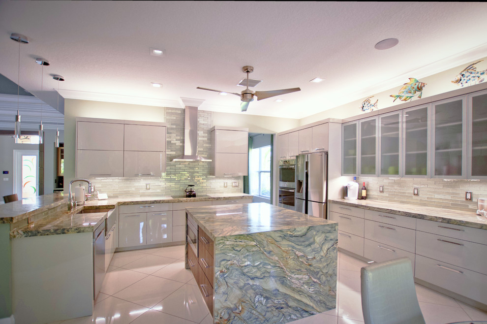 Design ideas for a large contemporary u-shaped open plan kitchen in Miami with a farmhouse sink, flat-panel cabinets, green cabinets, granite benchtops, green splashback, glass tile splashback, stainless steel appliances, marble floors, with island, white floor and green benchtop.