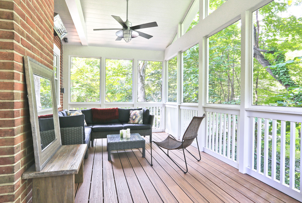 This is an example of a small traditional side yard screened-in verandah in DC Metro with decking and a roof extension.