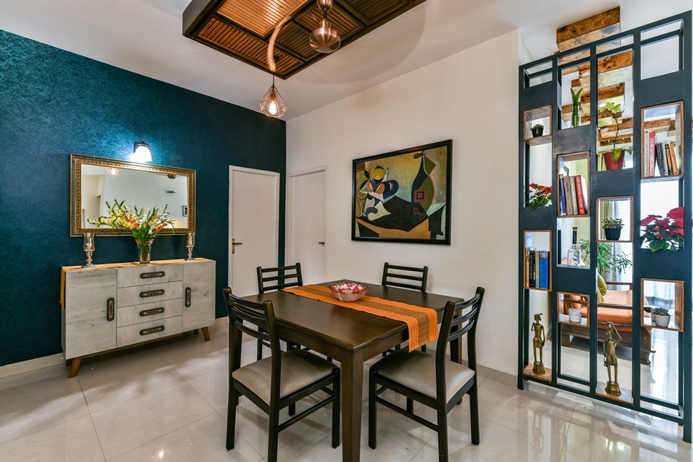 Eclectic dining room in Delhi with white walls and beige floor.
