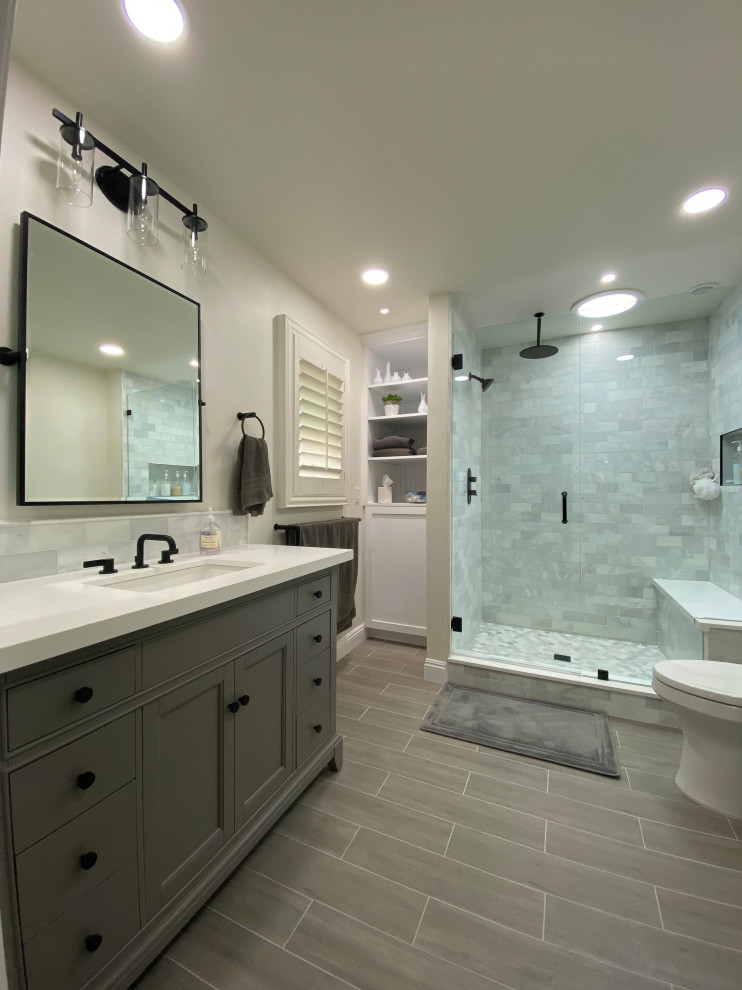 Design ideas for a mid-sized modern master bathroom in Los Angeles with raised-panel cabinets, grey cabinets, white tile, marble, porcelain floors, quartzite benchtops, grey floor, white benchtops, a shower seat, a single vanity and a freestanding vanity.