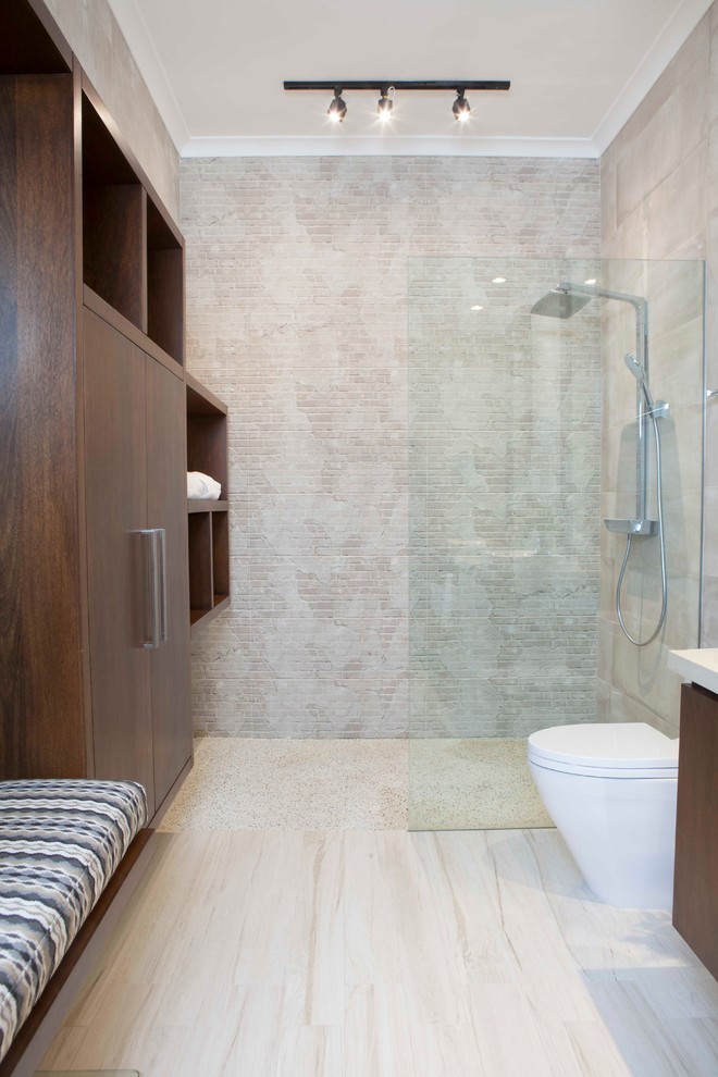 Photo of a transitional 3/4 wet room bathroom in Other with flat-panel cabinets, dark wood cabinets, beige tile, beige walls, beige floor and an open shower.