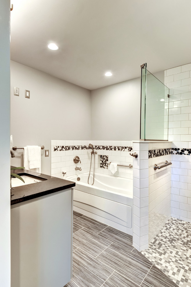 Traditional master bathroom in Philadelphia with flat-panel cabinets, grey cabinets, a drop-in tub, a curbless shower, white tile, porcelain tile, porcelain floors, an undermount sink, multi-coloured floor, an open shower, a one-piece toilet, grey walls, engineered quartz benchtops and grey benchtops.