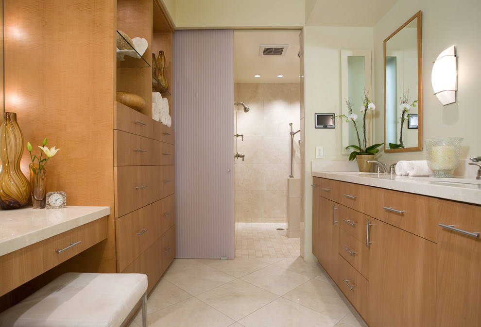 This is an example of a mid-sized contemporary master bathroom in San Diego with an undermount sink, flat-panel cabinets, an alcove shower, beige tile, medium wood cabinets, beige walls, limestone floors, quartzite benchtops and beige benchtops.