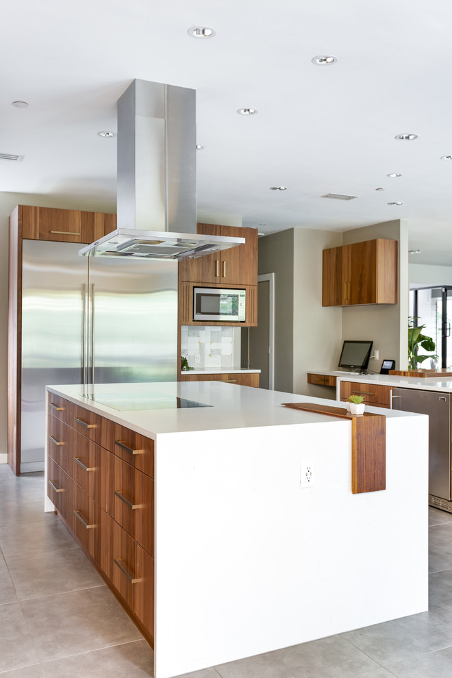 Inspiration for an expansive modern u-shaped eat-in kitchen in Dallas with a single-bowl sink, flat-panel cabinets, medium wood cabinets, quartz benchtops, grey splashback, marble splashback, stainless steel appliances, porcelain floors, multiple islands, grey floor and white benchtop.