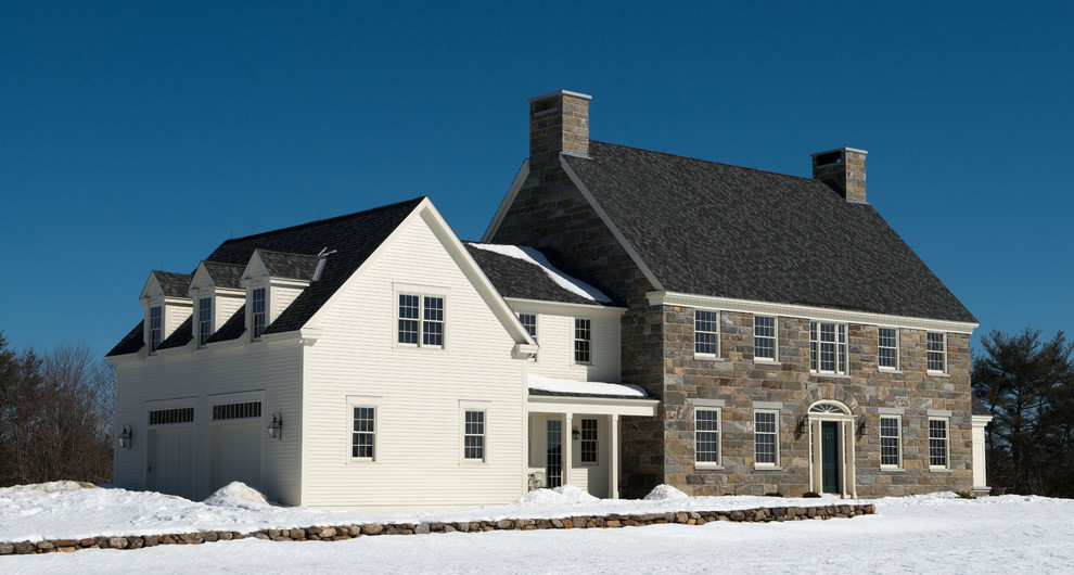 Large traditional two-storey exterior in Boston with stone veneer.