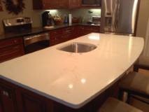 Inspiration for a mid-sized kitchen remodel with an undermount sink, quartz countertops and an island