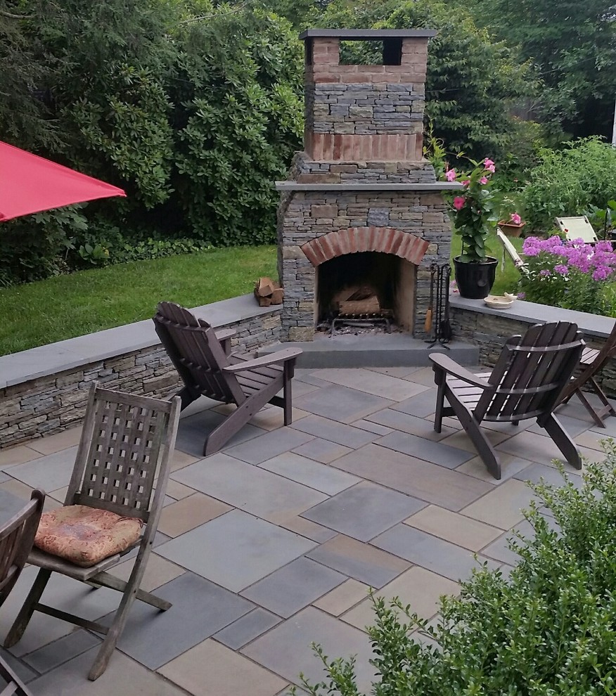 Mid-sized country backyard patio in Philadelphia with a fire feature and natural stone pavers.