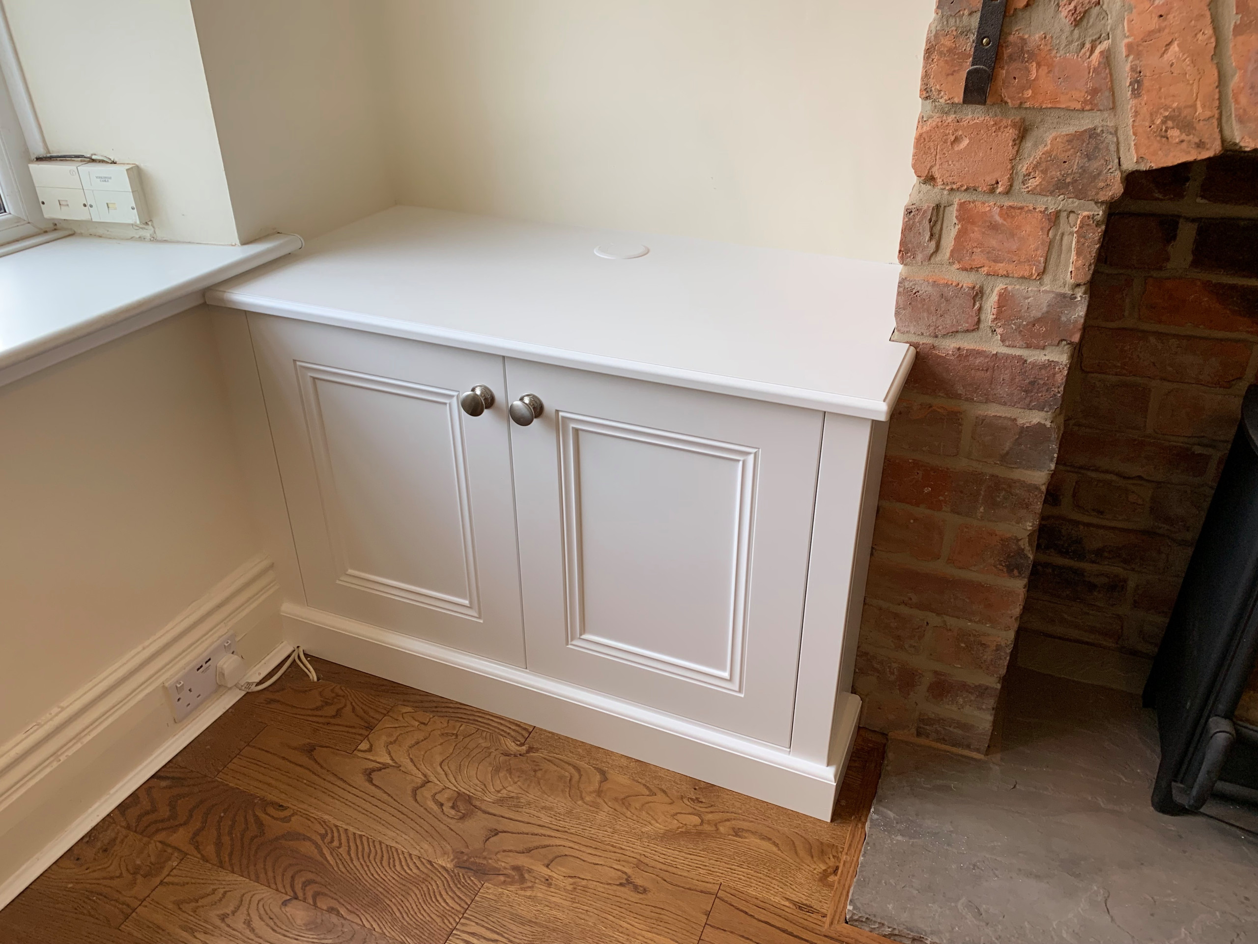 Classic Alcove Base Cabinet Against Rough Brick Chimney Breast