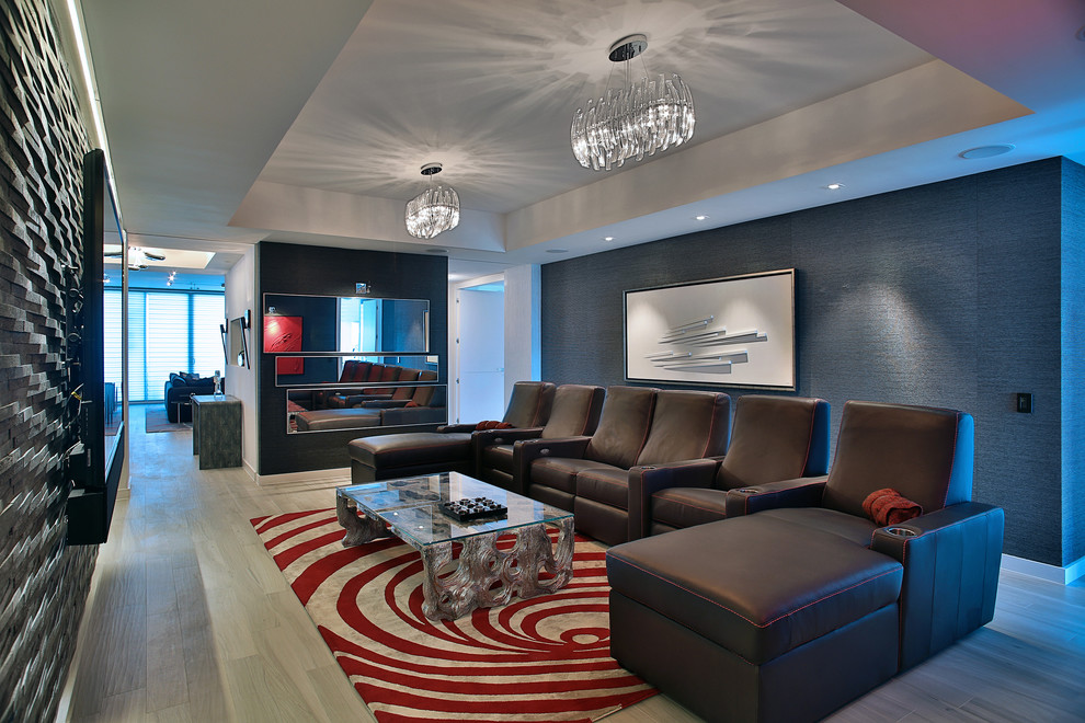 This is an example of a large contemporary family room in Miami with grey walls, porcelain floors and a wall-mounted tv.