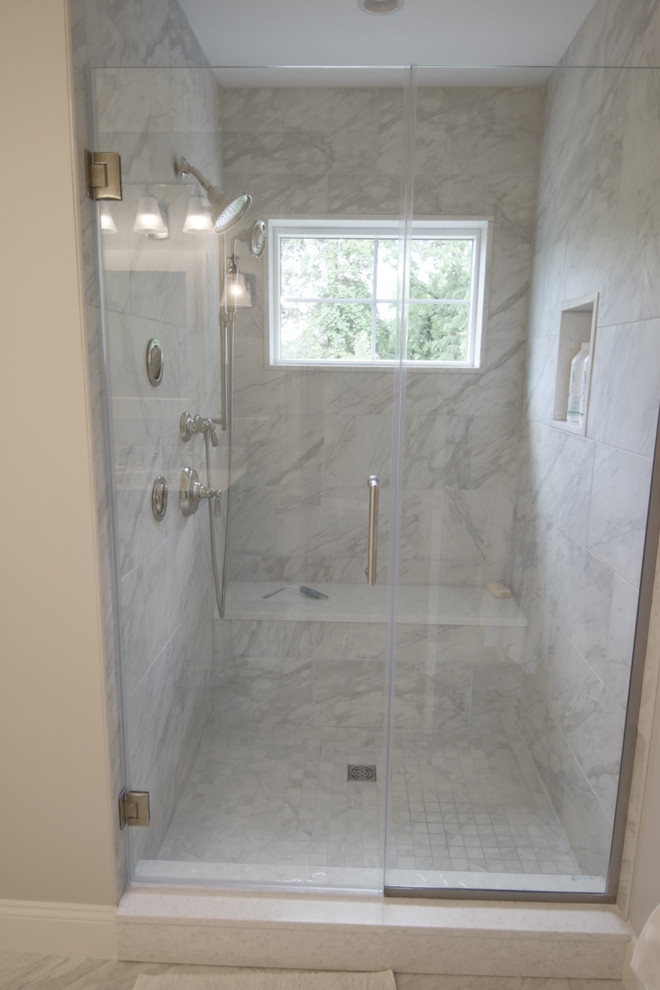 This is an example of a mid-sized traditional master bathroom in Boston with shaker cabinets, white cabinets, an alcove shower, a two-piece toilet, ceramic tile, beige walls, ceramic floors, an undermount sink, quartzite benchtops, grey floor and a hinged shower door.