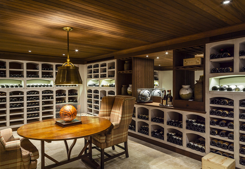 Inspiration for an expansive traditional wine cellar in New York with ceramic floors and display racks.