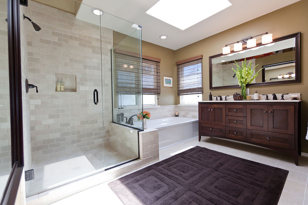 Photo of a large traditional master bathroom in Los Angeles with shaker cabinets, dark wood cabinets, an alcove tub, a corner shower, beige tile, an undermount sink, brown walls and porcelain tile.