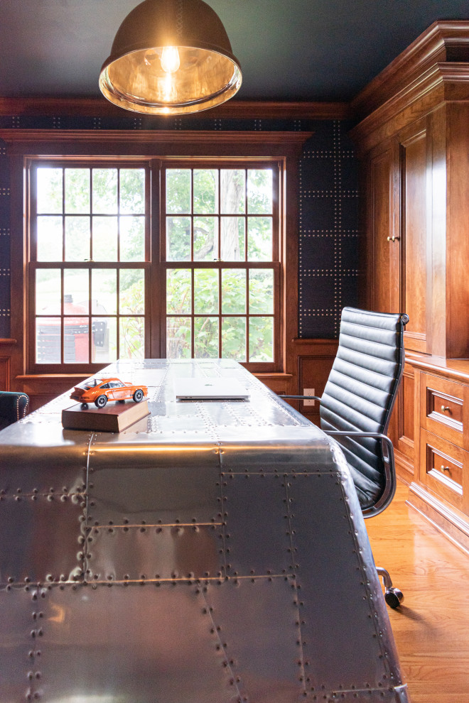 This is an example of a mid-sized traditional study room in Philadelphia with blue walls, medium hardwood floors, a freestanding desk, brown floor and wallpaper.