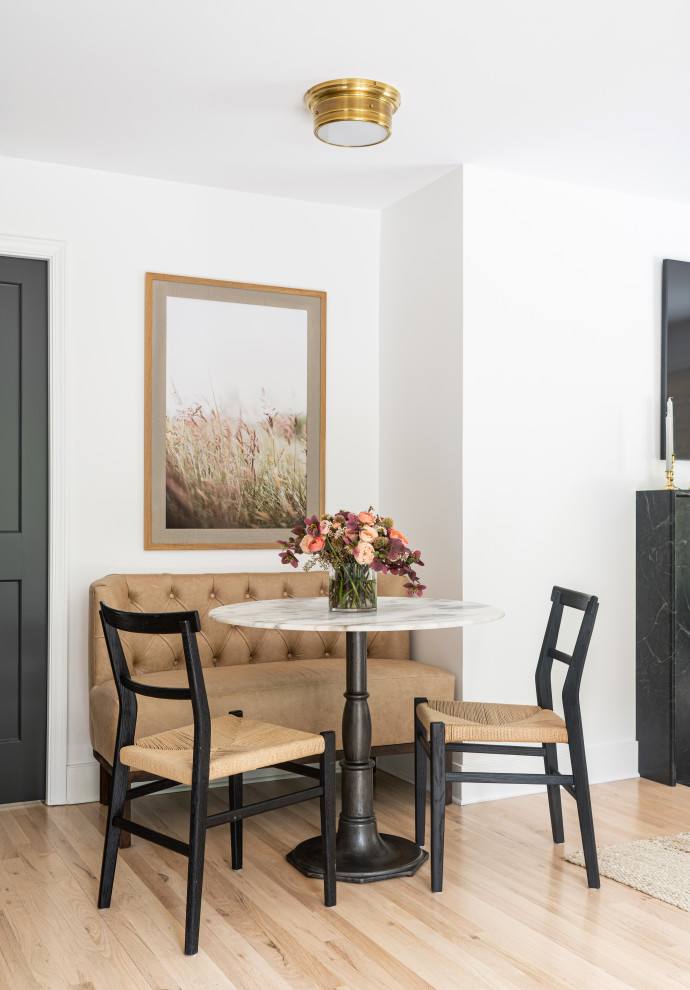 Transitional light wood floor and beige floor breakfast nook photo in Seattle with white walls