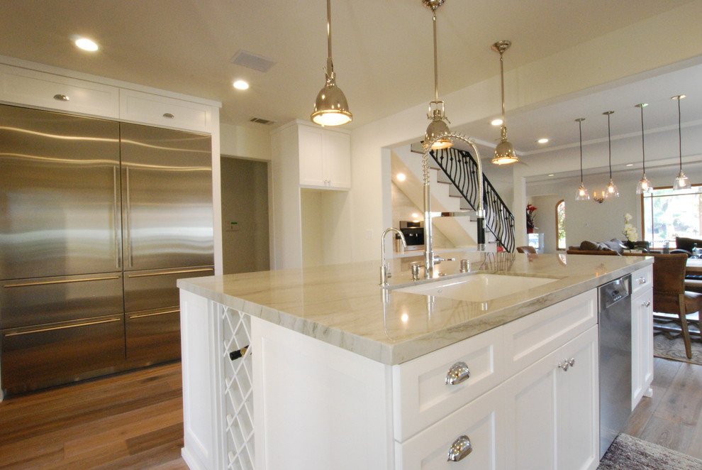 Design ideas for a transitional eat-in kitchen in Los Angeles with shaker cabinets, white cabinets and with island.