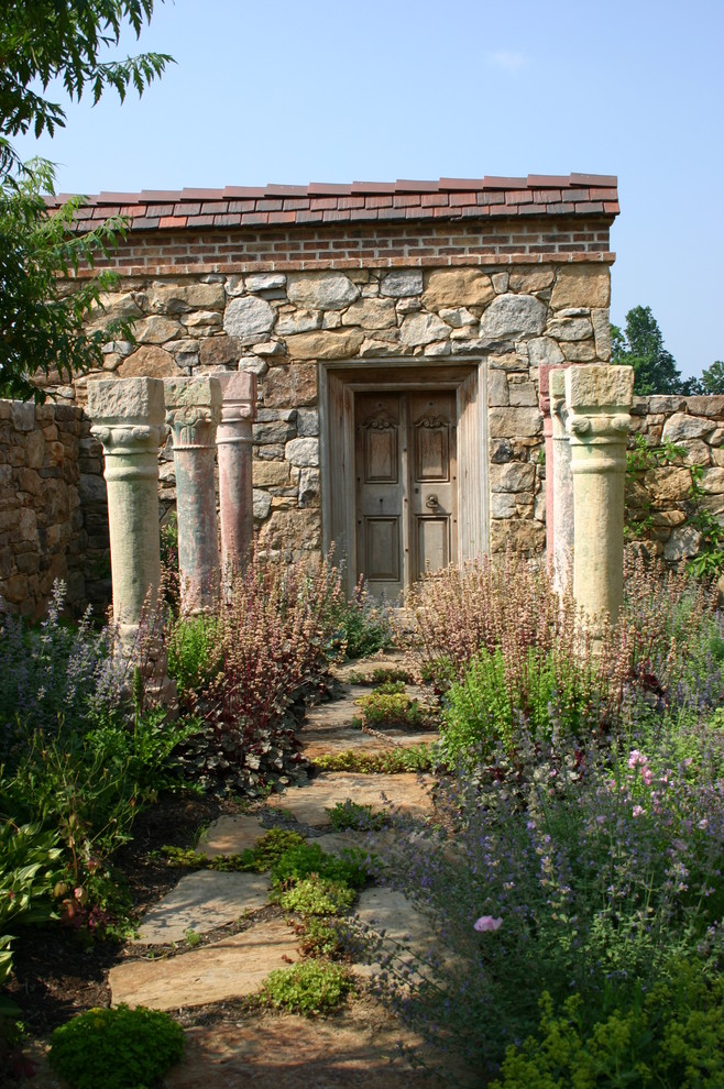 This is an example of a rustic back garden in Philadelphia with natural stone paving.