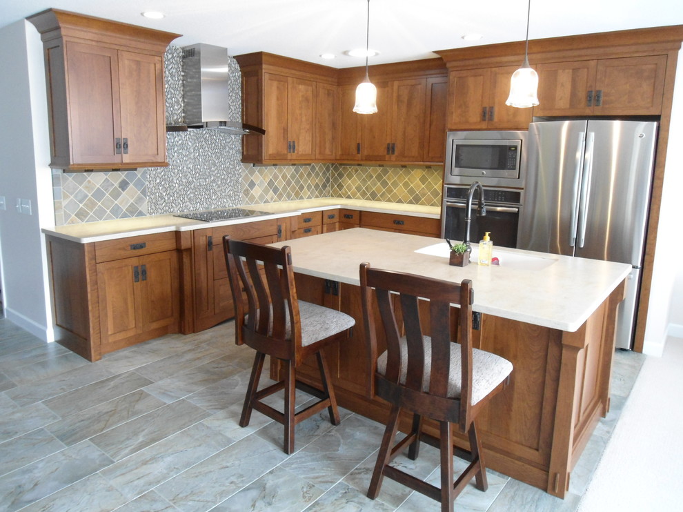 Small arts and crafts l-shaped open plan kitchen in Other with an integrated sink, shaker cabinets, medium wood cabinets, solid surface benchtops, stainless steel appliances and with island.