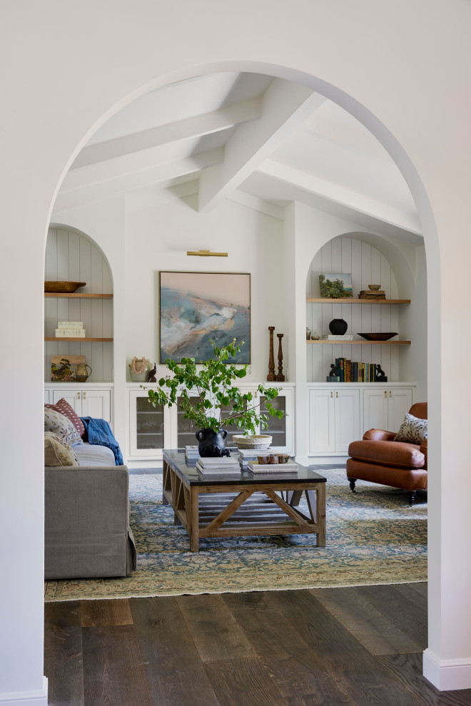 Inspiration for a large country enclosed living room in San Francisco with a library, white walls, dark hardwood floors, exposed beam and planked wall panelling.