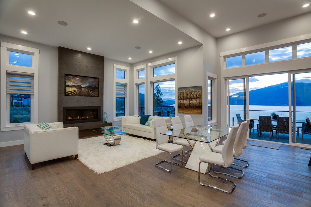 Large contemporary open concept living room in Vancouver with grey walls, medium hardwood floors, a ribbon fireplace, a stone fireplace surround and a wall-mounted tv.