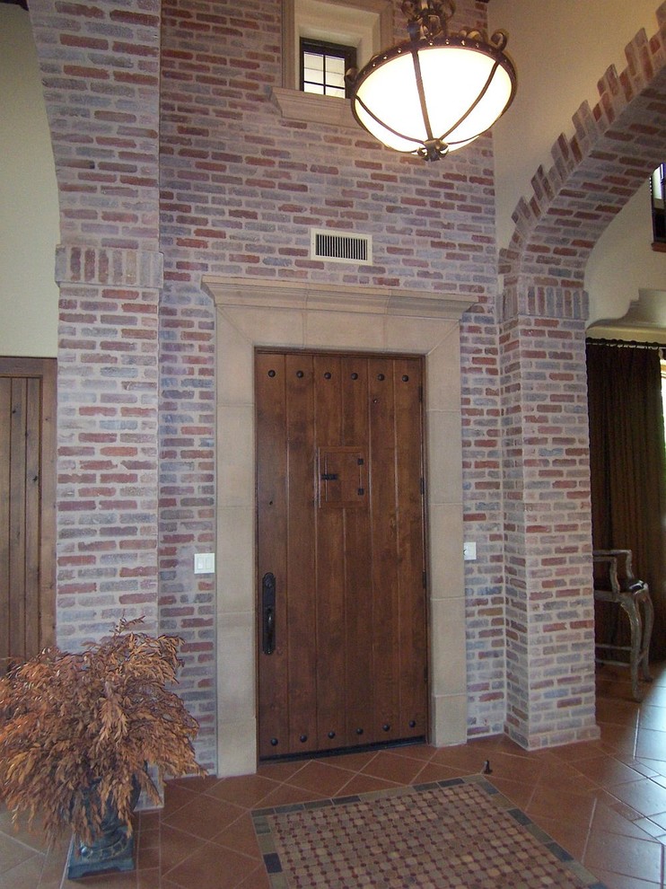 Front door - large mediterranean ceramic tile front door idea with a medium wood front door