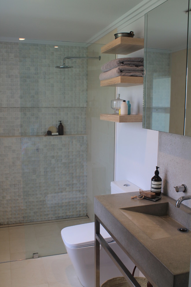 Inspiration for a small eclectic 3/4 bathroom in Sydney with an integrated sink, concrete benchtops, an open shower, a one-piece toilet, beige tile, stone tile, white walls and travertine floors.