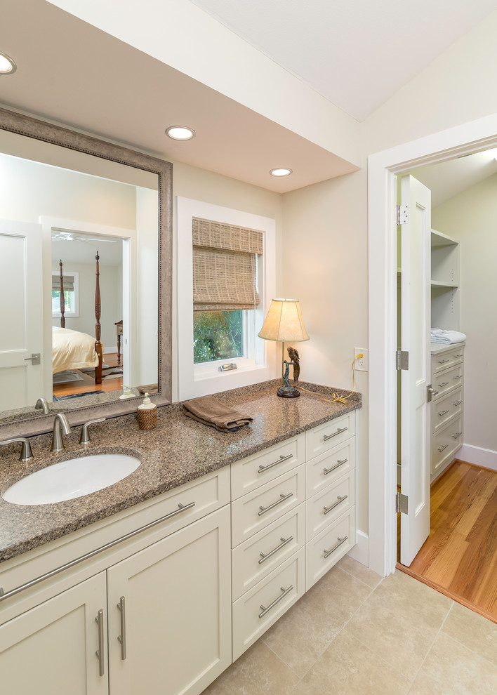 Inspiration for a mid-sized traditional master bathroom in Atlanta with an undermount sink, shaker cabinets, white cabinets, onyx benchtops, a corner shower, a one-piece toilet, multi-coloured tile, beige walls and porcelain floors.